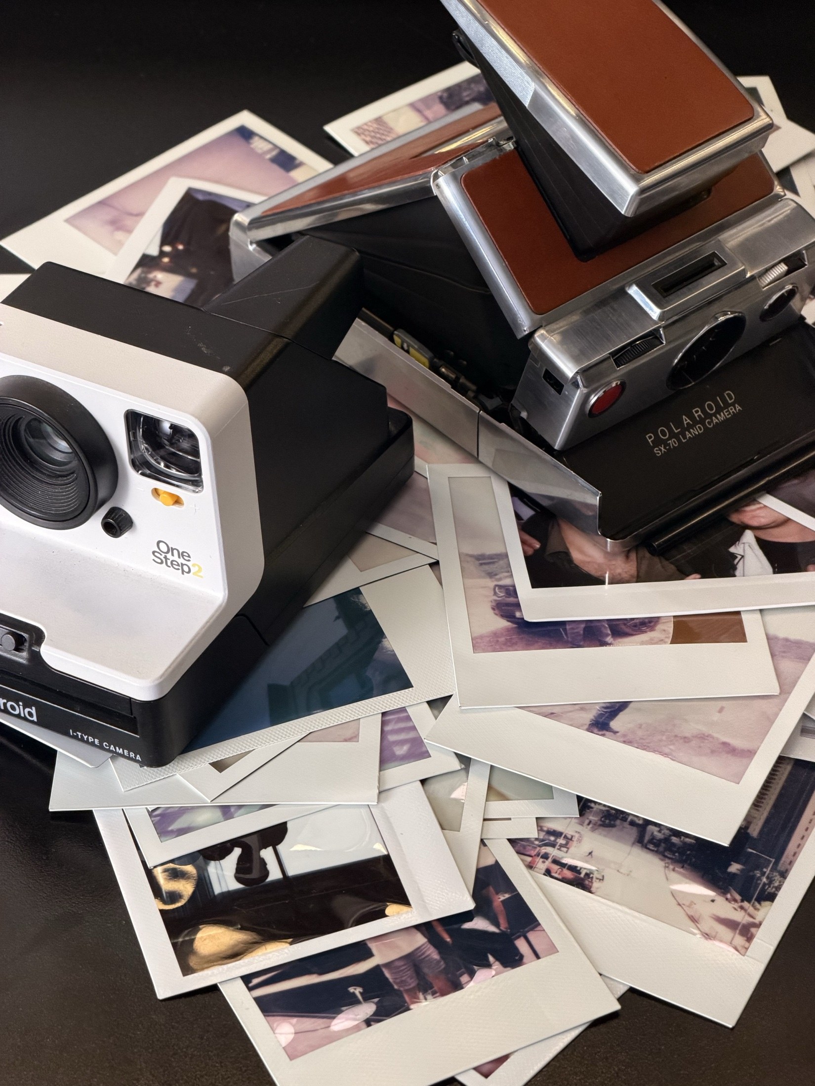 Instant cameras and prints on a table